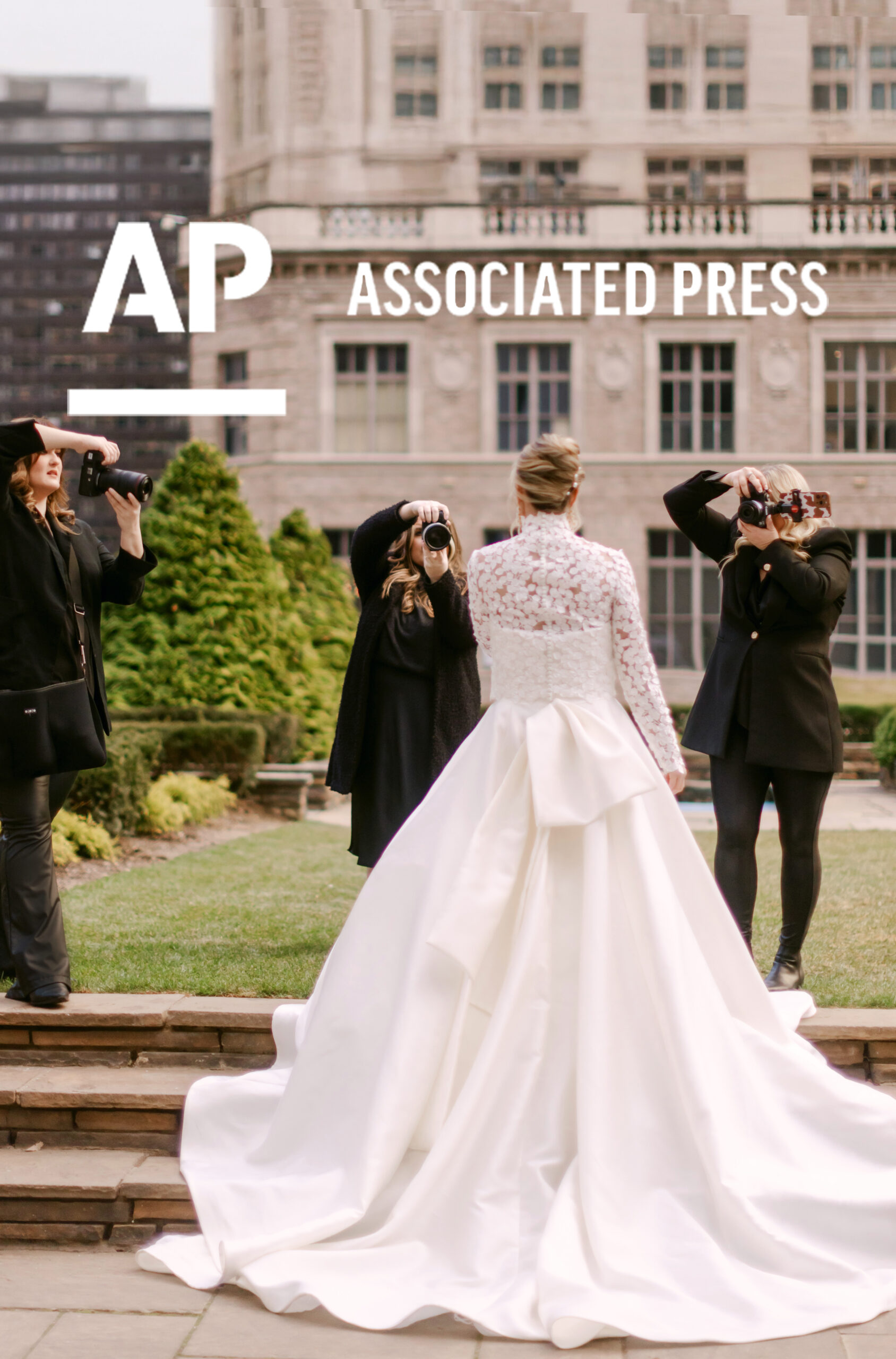 Three wedding photographers photographing a bride in a long white gown during a styled shoot at 620 Loft and Garden, featured in an Associated Press article.